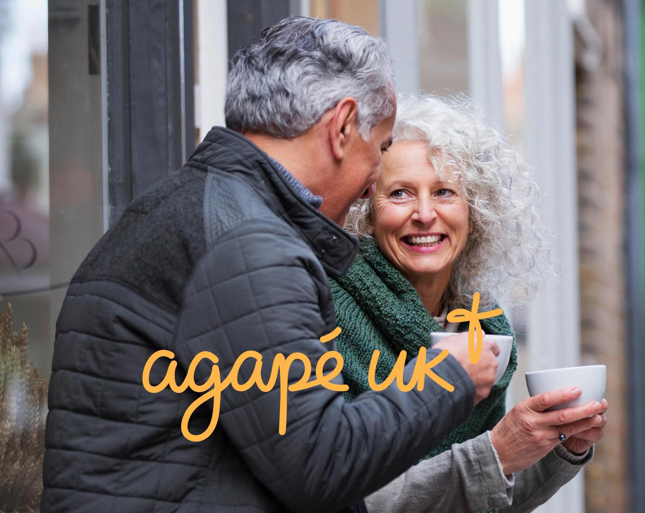 old couple talking outside with a cup of coffee