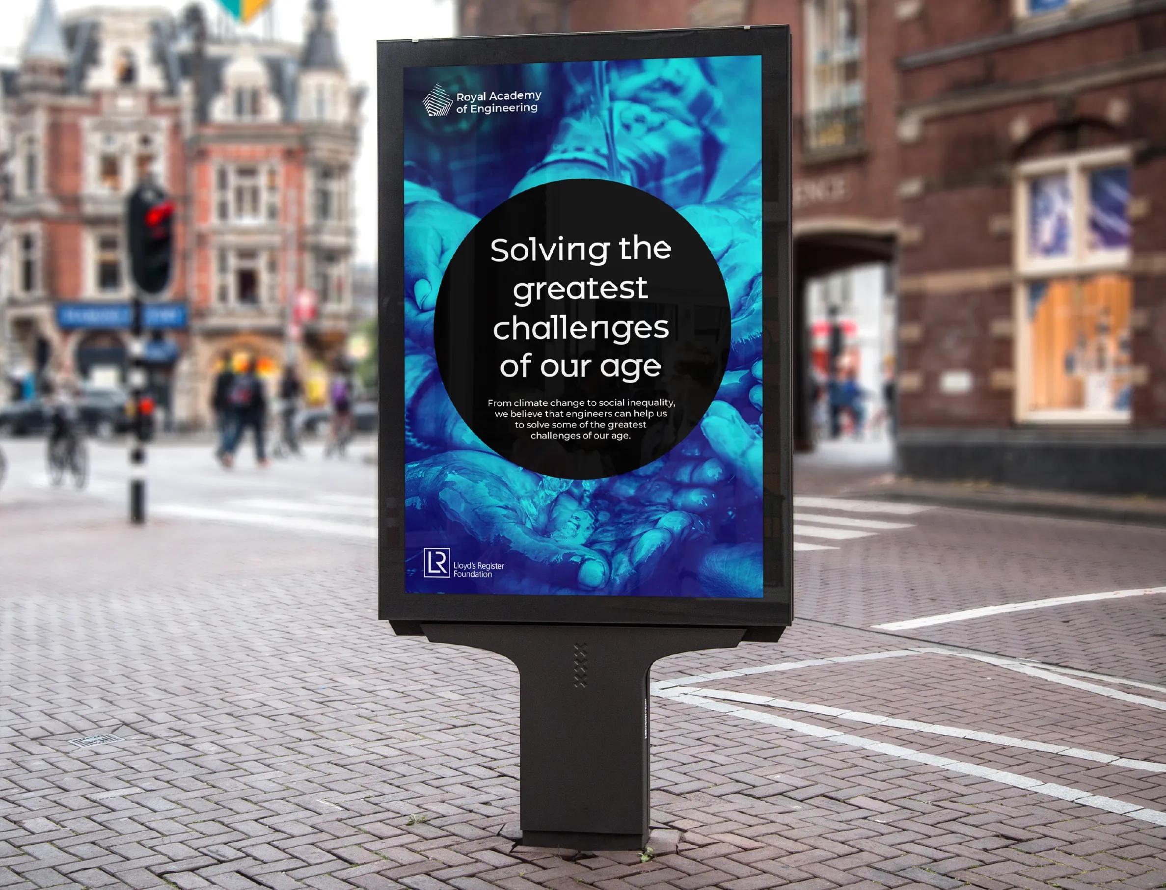 Electric billboard saying 'Solving the greatest challenges of our age'