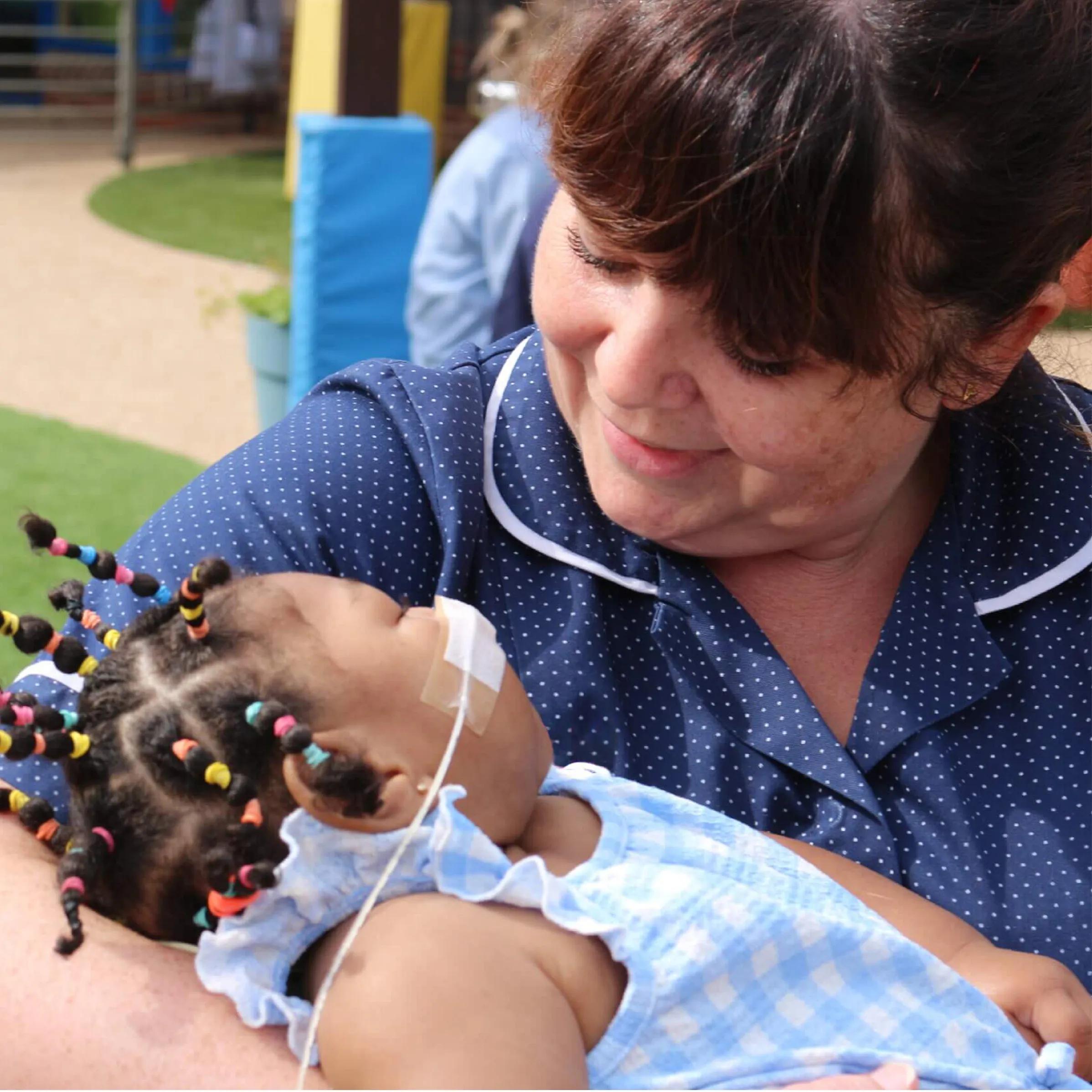 Nurse holding a child in her arms