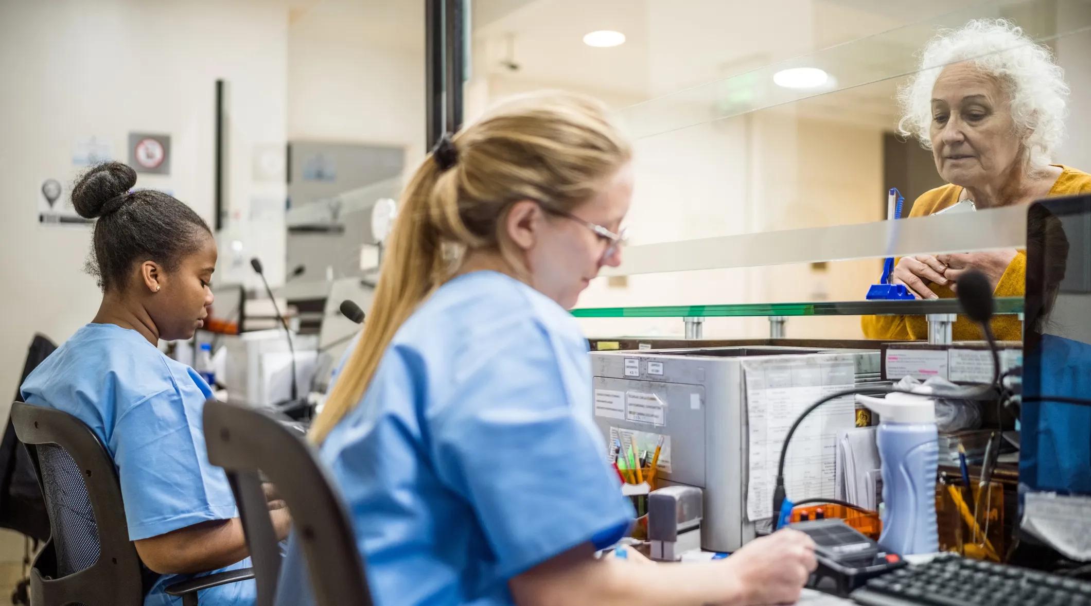 Patient talking to receptionist 