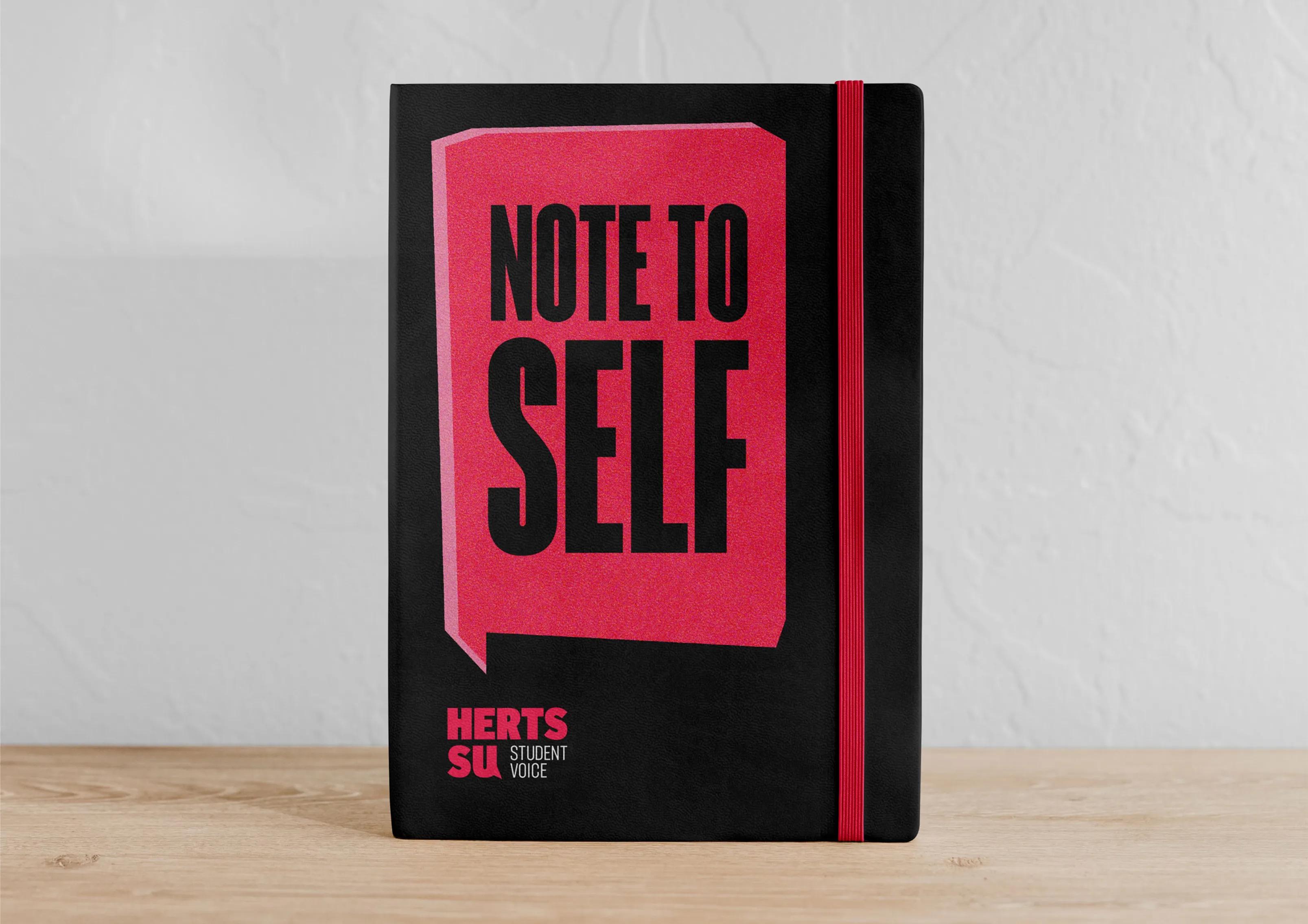A notebook with the caption 'note to self'