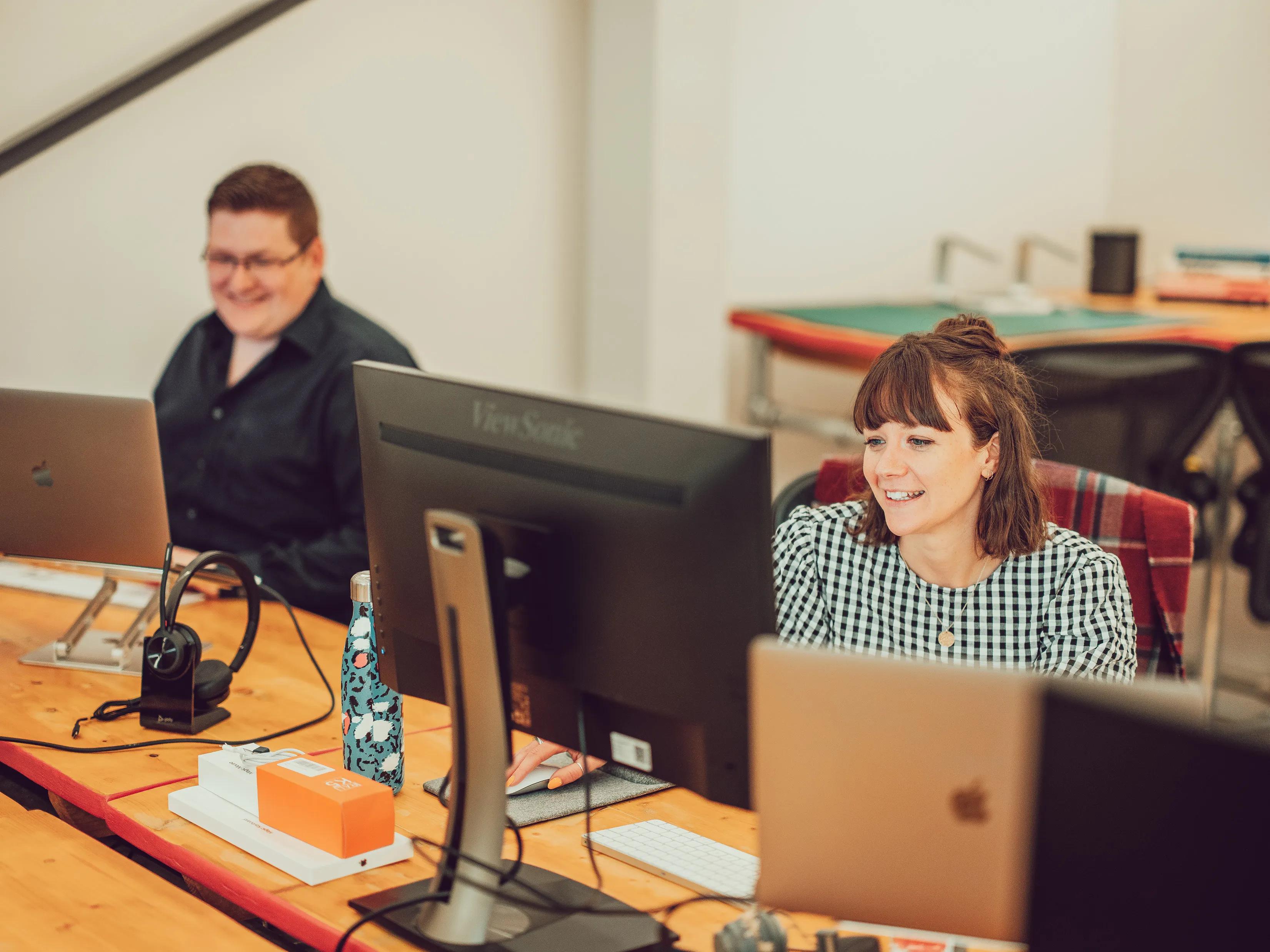 Josie and Dave working at their desks