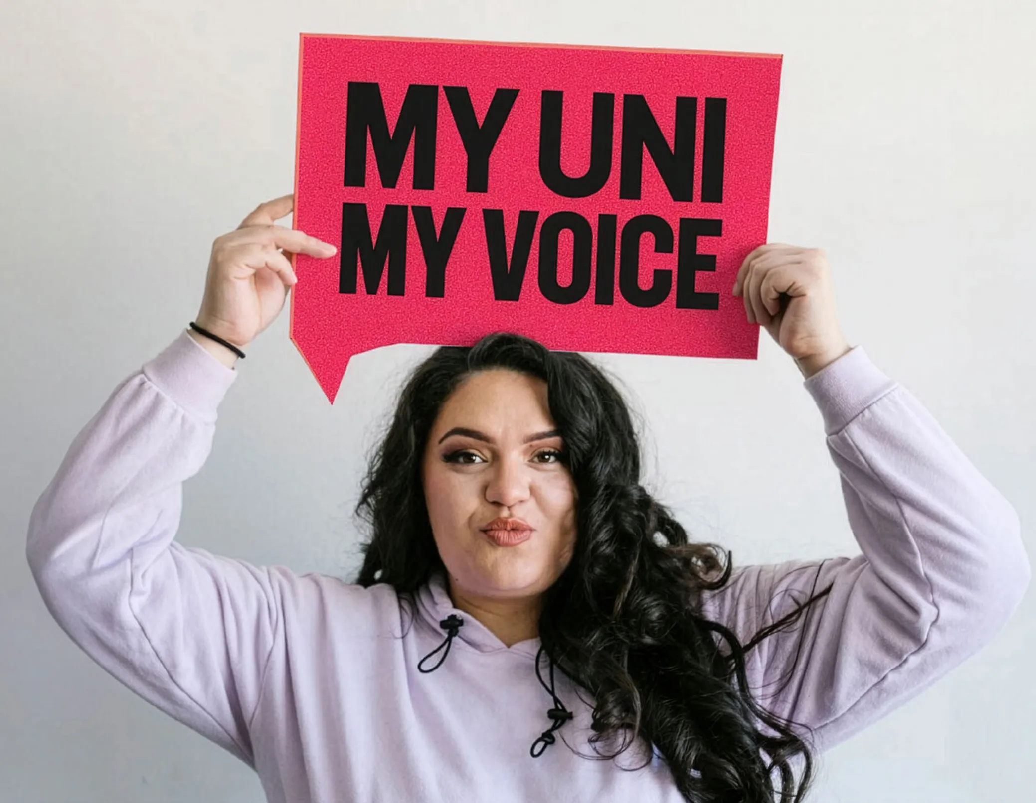Woman holding up a sign saying 'my uni, my voice'